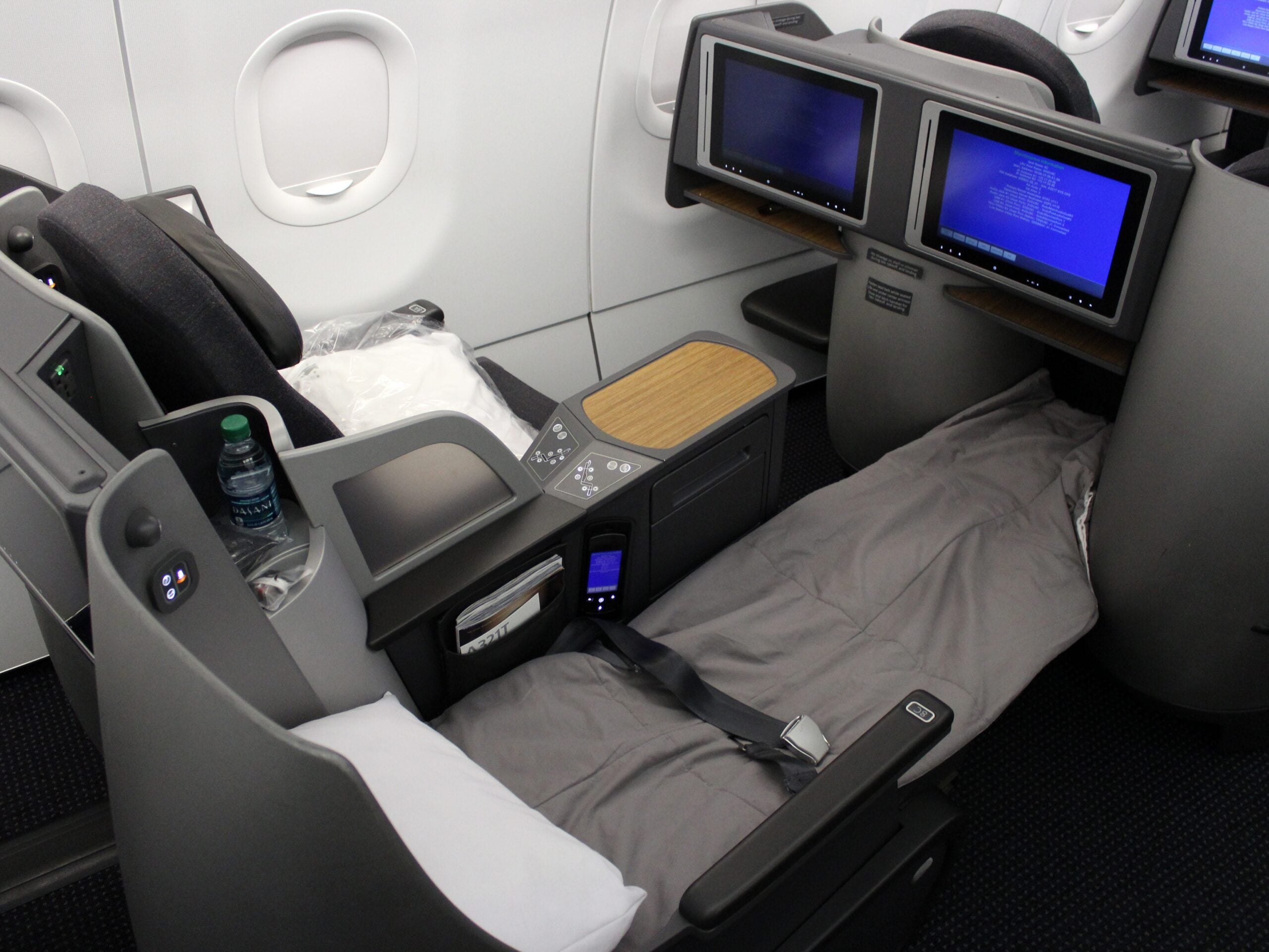 American's A321T business class with the aisle seat bed down.